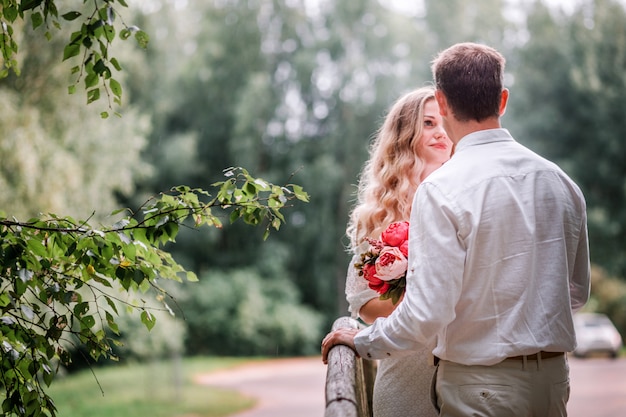 Bride and groom posing on a bridge