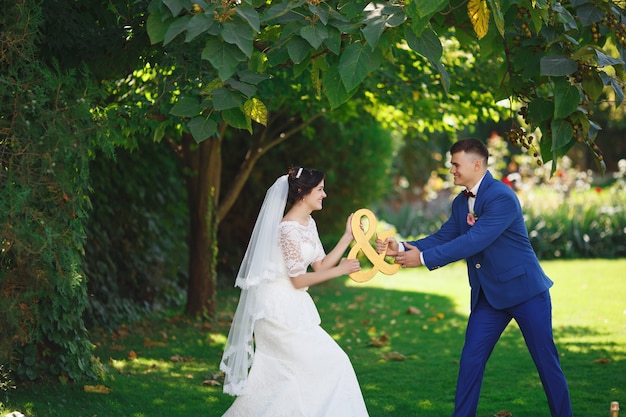 Bride and groom posing in a garden