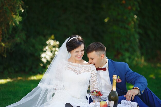 Bride and groom posing in a garden