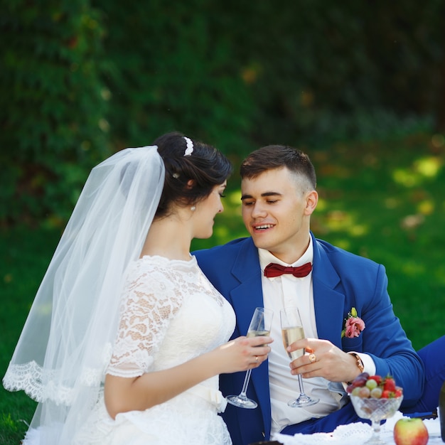 Side view of young romantic wedding couple holding face to face outdoors  Stock Photo - Alamy