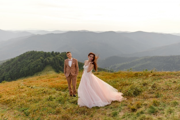 Bride and groom posing in the mountains