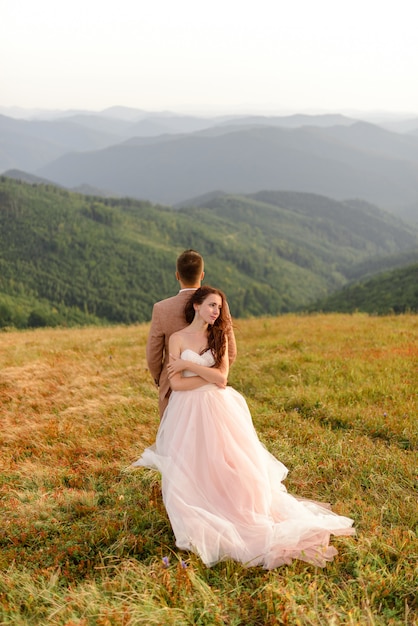 Bride and groom posing in the mountains