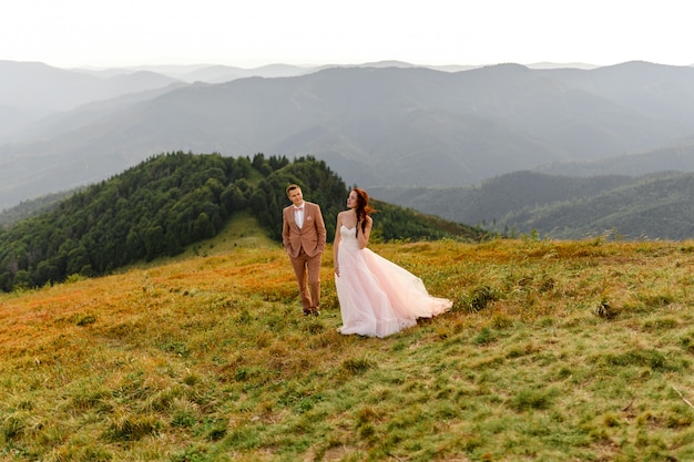 Bride and groom posing in the mountains