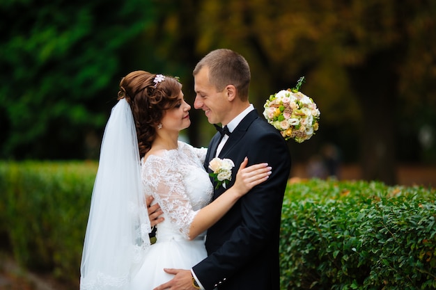 Bride and groom posing in nature