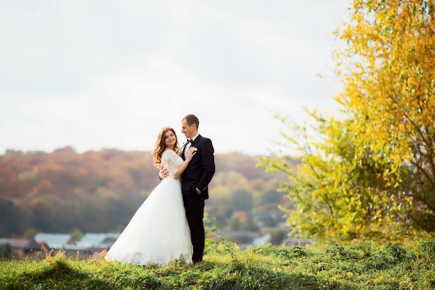 Bride and groom posing in nature