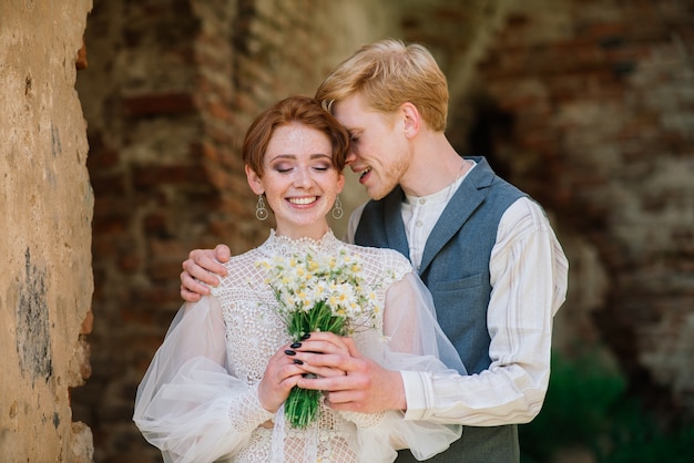 Bride and groom posing outdoors