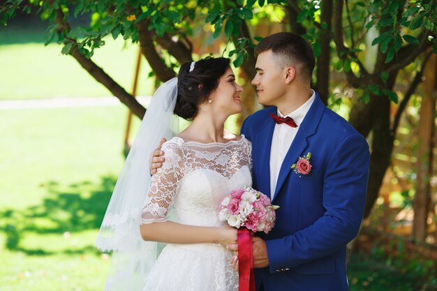 Bride and groom posing in a park