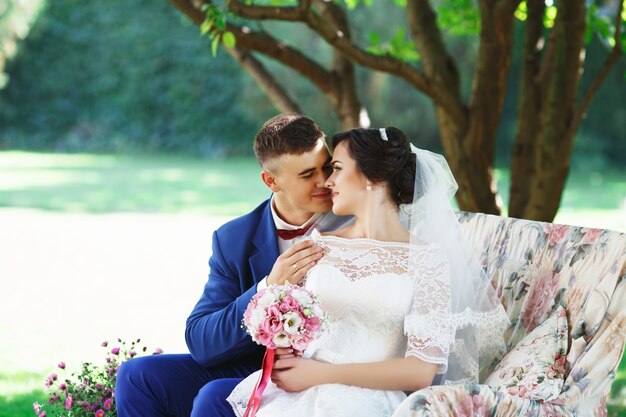 Bride and groom posing in a park