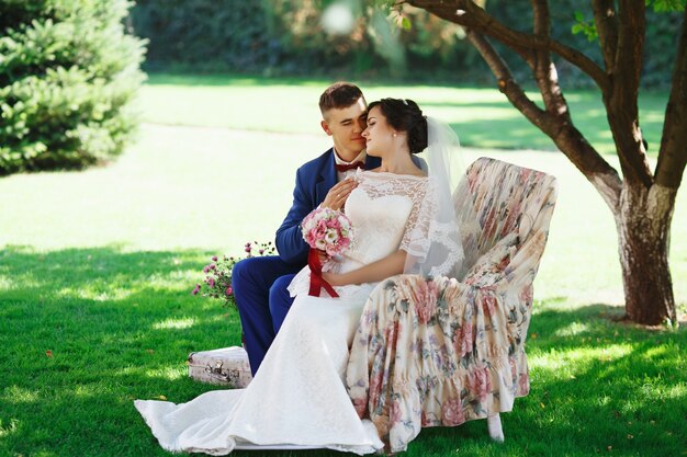 Bride and groom posing in a park