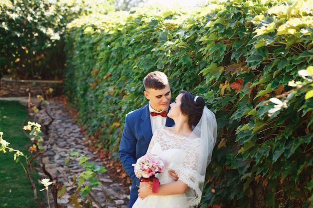 Bride and groom posing in a park