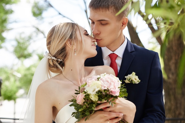 Bride and groom posing in a park