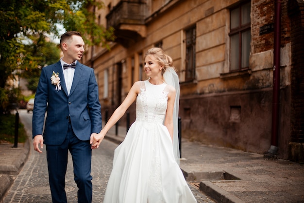 Bride and groom posing on the streets of the old city, close to the angle