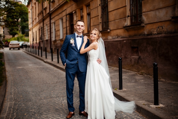 Bride and groom posing on the streets of the old city, close to the angle