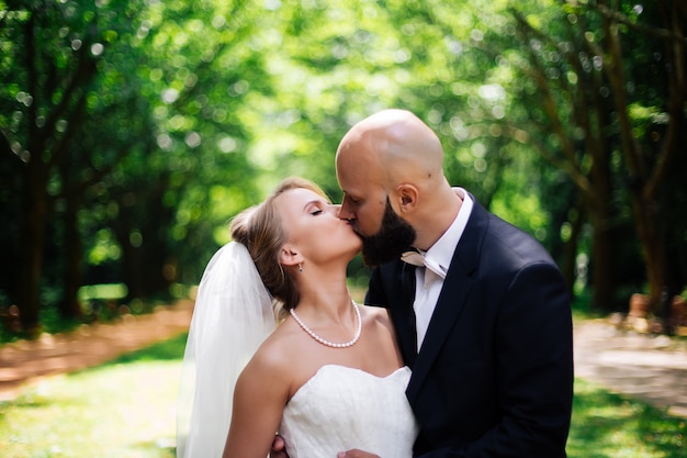 Bride and groom posing together in nature