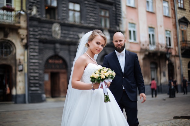 Bride and groom posing together in nature