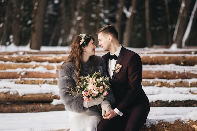 Bride and groom among the snowy landscape.