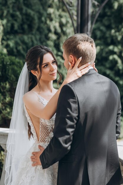 bride and groom stand in the garden