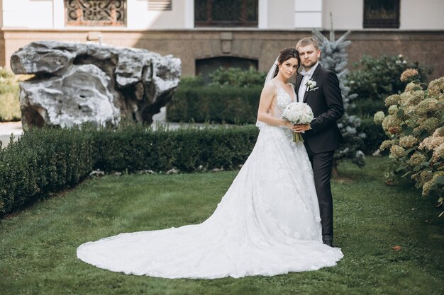 bride and groom stand in the garden