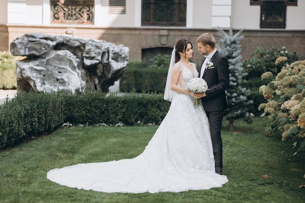 bride and groom stand in the garden