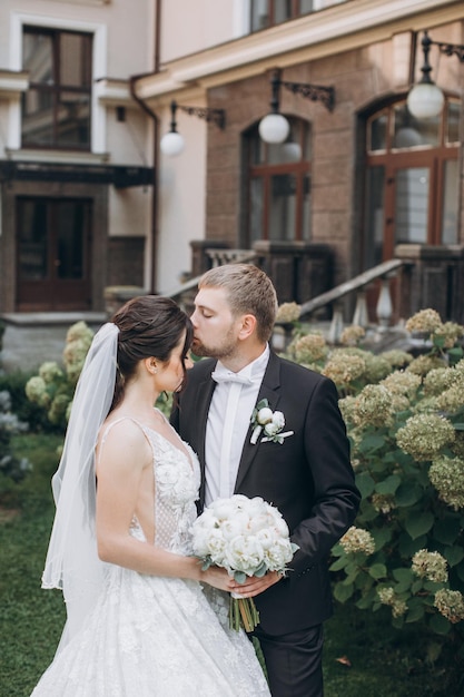 bride and groom stand in the garden