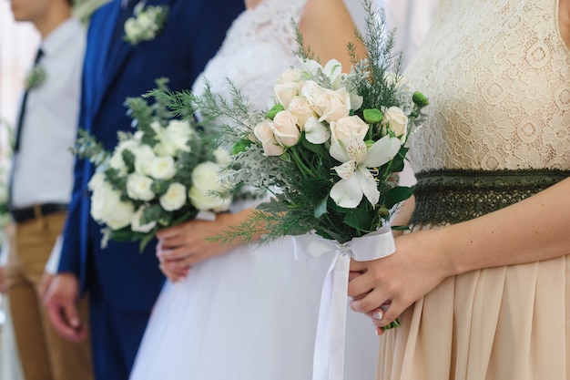 Bride and groom stand at the wedding ceremony