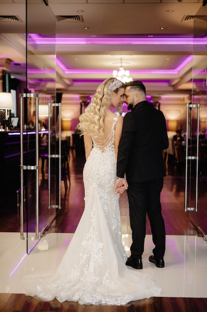 Bride and groom standing in a hotel lobby