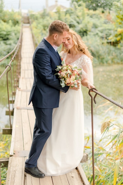 Bride and groom staying on the bridge