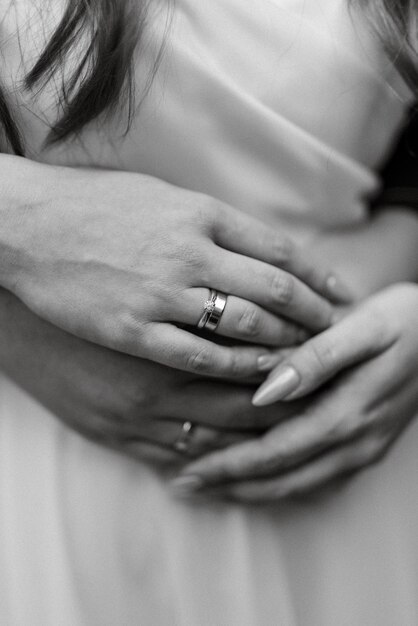 The bride and groom tenderly hold hands between them love and relationships