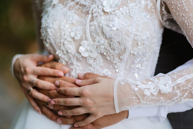 The bride and groom tenderly hold hands between them love and relationships