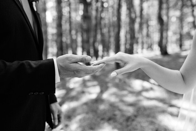 The bride and groom tenderly hold hands between them love and relationships