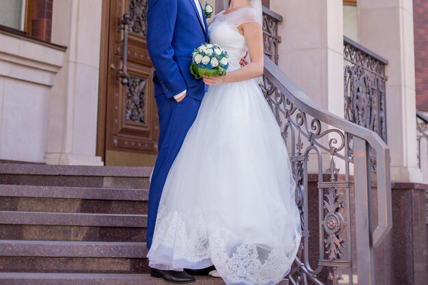 Bride and groom on the veranda of the house