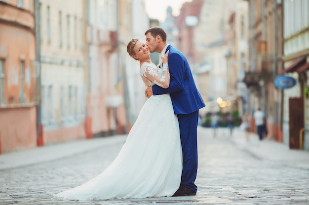 Bride and groom walk around the old town