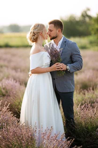 Bride and groom on a walk in the lavender field