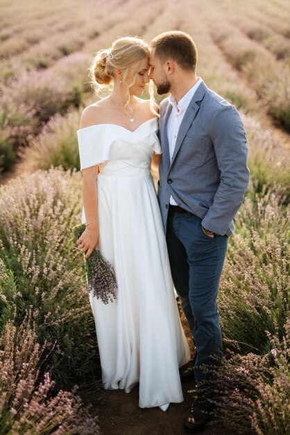 Bride and groom on a walk in the lavender field