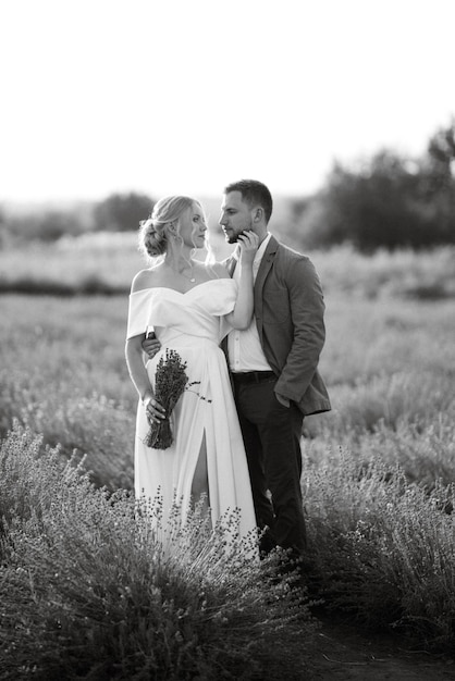 Bride and groom on a walk in the lavender field