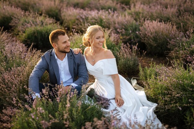 Bride and groom on a walk in the lavender field