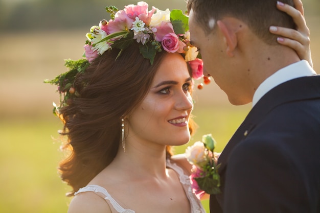 The bride and groom walk at sunset.