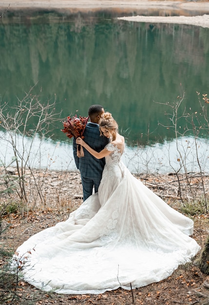 Bride and groom at wedding ceremony on the beautiful lake.