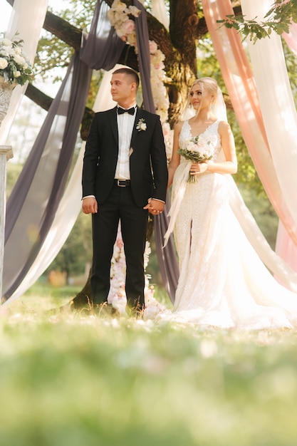 Bride and groom on wedding ceremony outside