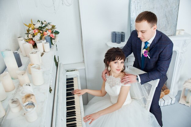 Bride and groom in wedding clothes embrace at home. Couple in love after a wedding ceremony