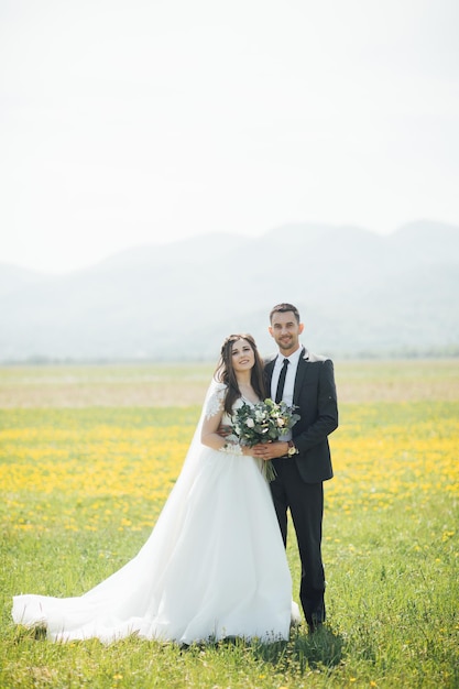 Bride and Groom at wedding Day walking Outdoors on summer green nature.