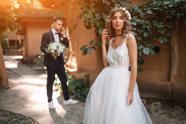 Bride and groom at wedding Day walking Outdoors on summer nature.