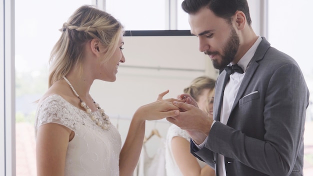 Bride and groom in wedding dress prepare ceremony.