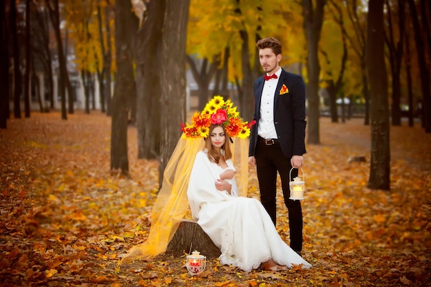 A bride and groom in a wedding dress with a sunflower crown