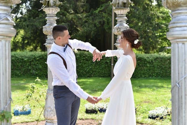 Bride and groom at a wedding in a green park