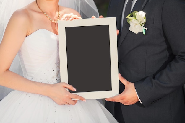 Bride and groom with blank placard for any title