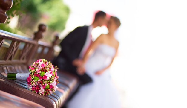 Bride and groom with bridal bouquet in front