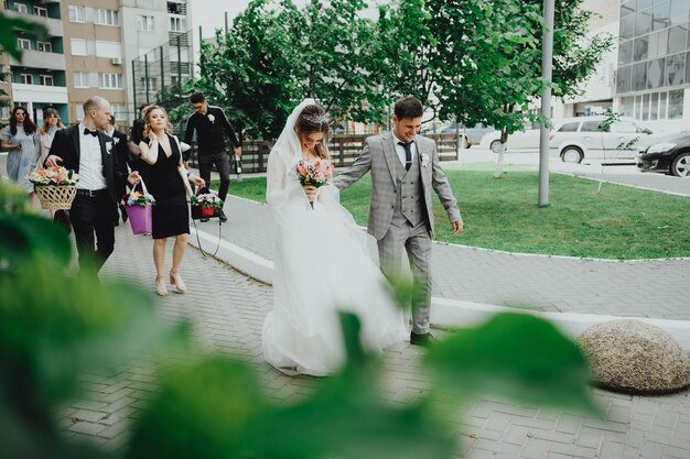 The bride and groom and the youth walk