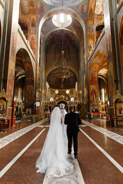 bride and groomduring wedding ceremony in christian church