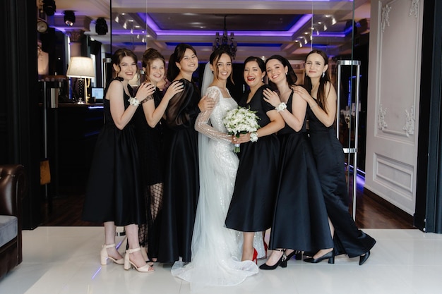 a bride and her bridesmaids pose for a photo in front of a mirror